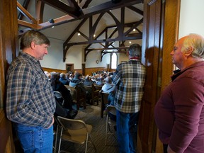 Farmers are left standing at the back of a crowded Middlesex County building in London on Tuesday as they attend a county meeting to talk about lowering the farmland tax assessment. (Mike Hensen/The London Free Press)