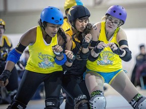 A group of roller derby competitors crush together during competition. Roller derby had its heyday in the 1970s but has been rising in popularity in the last 10 years. 
(Mark Girdauskus at Photos by MG)