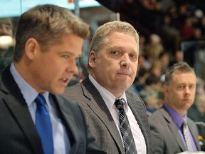 Bulls GM-coach George Burnett is flanked by assistants Jason Supryka (left) and Jake Grimes during a 2013-14 OHL contest at Yardmen Arena. (TERRY WILSON/OHL Images)