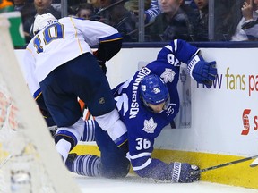 The Blues' Brenden Morrow knocks down Leafs' Carl Gunnarsson during St. Louis' 5-3 win over Toronto on Tuesday. (Dave Abel/Toronto Sun)