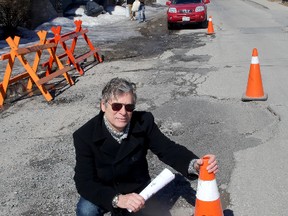 Kingston resident Dwight Druick at York Street and Raglan Road on Wednesday, where he claims received $570 in damage to his vehicle after going over a large pothole. 
IAN MACALPINE/KINGSTON WHIG-STANDARD/QMI AGENCY