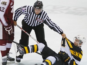 A linesman separates Peterborough Petes’ Matt McCartney and Kingston Frontenacs’ Sam Bennett during Game 3 of an OHL Eastern Conference quarter-final series on Tuesday at the Memorial Centre in Peterborough. (Clifford Skarstedt/QMI Agency)