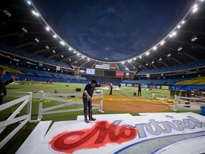 WorkerS at Olympic Stadium make preparations for the Blue Jays-Mets series with weekend in Montreal. (BEN PELOSSE/QMI AGENCY)