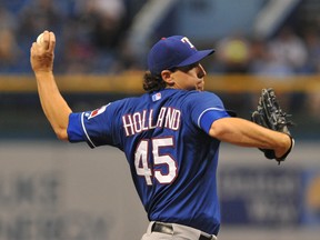 The Rangers lost starter Derek Holland until mid-season after the lefty tripped over his dog and hurt his knee. And that wasn’t the only weird off-season injury to befall Texas. (AFP)