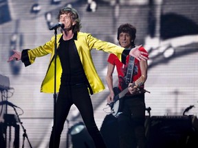 Mick Jagger (L) and Ronnie Wood of the Rolling Stones perform during a concert in Shanghai, March 12, 2014. (REUTERS/Stringer)