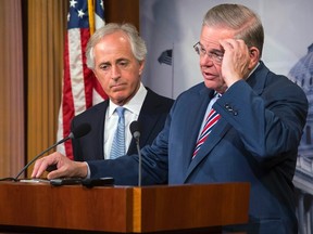 U.S. Senate Foreign Relations Committee Chairman Robert Menendez (D-NJ) (R) and ranking member Senator Bob Corker (R-TN) (L) hold a news conference after a Senate vote on an aid package for Ukraine at the U.S. Capitol in Washington March 27, 2014. (REUTERS/Jonathan Ernst)
