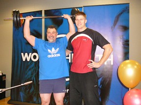 Cary Castagna, left, celebrates his progress with World Health trainer Dennis Brent.