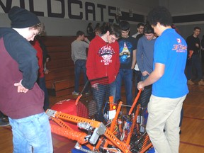 West Elgin Secondary School students examine a robot brought to their school by Sir Wilfrid Laurier Secondary School students. West Elgin is considering starting a club to build and operate robots.