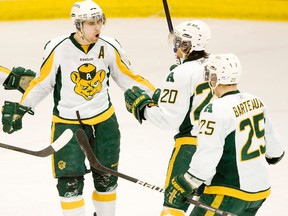 Colin Joe, centre, and Ian Barteaux congratulate Bears teammate Lee Zalasky after a goal during the 2010 CIS playoffs. (Edmonton Sun file)