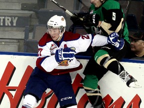 The Edmonton Oil Kings Curtis Lazar (27) battles the Prince Albert Raiders Tomas Andrlik (5) during second period WHL action at Rexall Place, in Edmonton Alta., on Saturday March 22, 2014. David Bloom/Edmonton Sun/QMI Agency