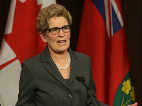 Ontario Premier Kathleen Wynne at Queen's Park in Toronto Thursday, March 27, 2014, responds to remarks made earlier by PC Leader Tim Hudak. (Dave Thomas/Toronto Sun)