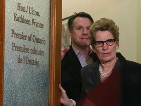 Ontario Premier Kathleen Wynne emerges from her office and reads a prepared statement to the media over the gas plant allegations Thursday March 27, 2014. (Jack Boland/Toronto Sun)