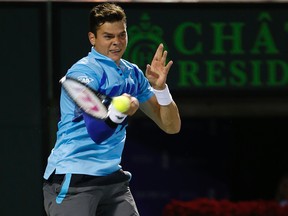 Milos Raonic hits a forehand back to Rafael Nadal during a quarterfinal match at the Sony Open in Miami on Thursday, March 27, 2014. (Geoff Burke/USA TODAY Sports)