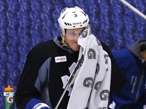 Leafs captain Dion Phaneuf uses a towel to wipe his visor at the team’s workout Thursday at the MasterCard Centre. (CRAIG ROBERTSON/Toronto Sun)