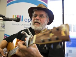 Busker Farley Magee plays a Beatles song during an Edmonton Public Library press conference announcing the expansion of the EPL’s outreach worker program at the Stanley Milner Library on Thursday. IAN KUCERAK/Edmonton Sun