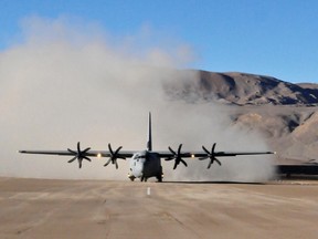 In this handout photograph released by the Ministry of Defence and taken on August 20, 2013, an Indian Air Force Lockheed Martin C-130J Super Hercules kicks up a cloud of dust after landing at the high-altitude Daulat Beg Oldie military airstrip in the Ladakh region of the Indian Himalayas. (AFP PHOTO/MINISTRY OF DEFENCE/FILES)