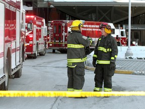 Winnipeg firefighters confer outside the Health Sciences Centre on Thursday following a chemical spill. (Brian Donogh/Winnipeg Sun)