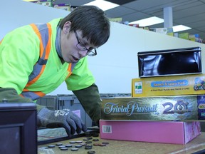 Sorting through the day’s donations, Noel Backs puts together the pieces of a board game before labelling and shelving the new item in the store.  Backs works twice a week at the Goodwill Donation Centre in Spruce Grove as a donation attendant. - Karen Haynes, Reporter/Examiner