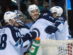 Winnipeg Jets center Bryan Little (18) and goalie Al Montoya (35) and defenceman Keaton Ellerby (7) celebrate after defeating the San Jose Sharks 4-3 at SAP Center at San Jose. (Ed Szczepanski-USA TODAY Sports)