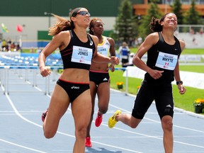 U.S. hurdler and Olympic bobsledder Lolo Jones, left, and Edmonton Olympian Angela Whyte cross the finish line during competition at last summer's Edmonton Track Classic at Foote Field. (Trevor Robb, Edmonton Sun)