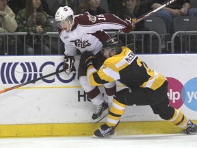 Michael Lea The Whig-Standard
Kingston's Evan McEneny takes Peterborough's Jonatan Tanus into the boards during first period action in their playoff game at the KRock Centre Friday night.