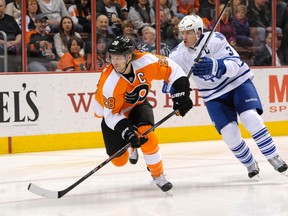 Philadelphia Flyers centre Claude Giroux (28) and Toronto Maple Leafs defenceman Dion Phaneuf (3) chase the puck into the corner during the first period at Wells Fargo Center in Philadelphia Friday, Mar 28, 2014. (Eric Hartline-USA TODAY Sports/Reuters)