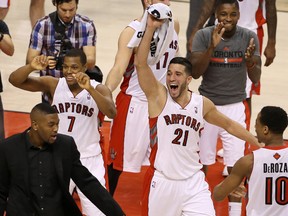 Toronto Raptors point guard Kyle Lowry (7) and guard Greivis Vasquez (21) celebrate their 105-103 victory against the Boston Celtics at Air Canada Centre and making the NBA playoffs March 28, 2014. (Tom Szczerbowski-USA TODAY Sports/Reuters)