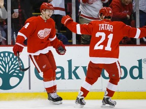 Detroit Red Wings centre Gustav Nyquist (left) receives congratulations from left winger Tomas Tatar (21) after scoring in the first period against the Minnesota Wild at Joe Louis Arena on March 23, 2014. (RICK OSENTOSKI/USA TODAY Sports)