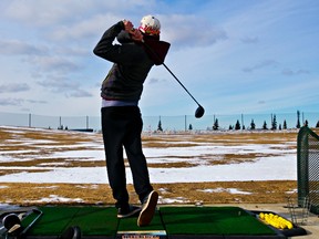 Matthew Zarowny hits a golf ball at the Mill Woods Golf Course driving range in Edmonton, Alta., on Monday, March 24, 2014. Codie McLachlan/Edmonton Sun/QMI Agency