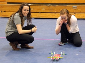 Kirsten Nickel (left) and Emily Schaefer of Northern look on as their self-powered car competes in a distance control challenge during the 2014 Impromptu Design Challenge at Lambton College on Saturday, March 29. Nickel's and Schaefer's team, The Energizer Bunnies, won the Design Challenge, held by the Professional Engineers of Ontario in conjunction with National Engineering Month. SHAUN BISSON/THE OBSERVER/QMI AGENCY