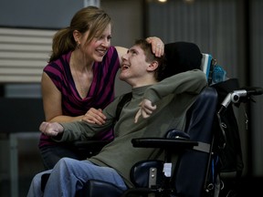 Nathan Devlin and his caregiver Renee Laporte pose for a photo at the Sun offices in Edmonton, Alberta on Friday, March 28, 2014.  Perry Mah/ Edmonton Sun/ QMI Agency