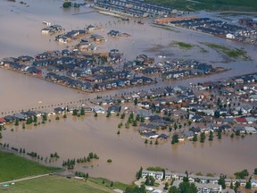 Houses are surrounded by flood waters in High River, Alta., south of Calgary on June 23, 2013. (REUTERS/Andy Clark)