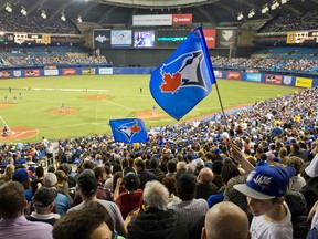 Fans wave Blue Jays banners at Olympic Stadium in Montreal on Saturday. (Joel LeMay/QMI Agency)