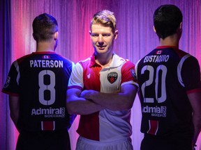 Ottawa Fury FC players, from right, Nicki Paterson, Richie Ryan and Mauro Eustquio, show of the team's kits during an event for season ticket holders Saturday, March 29, 2014 at Tailgators at Merivale Mall.  The Fury will be sporting the new gear starting with the regular season kick off in Fort Lauderdale on April 12.
Chris Hofley/Ottawa Sun/QMI AGENCY