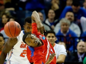 Dayton’s Scoochie Smith loses control of the ball as Florida’s Casey Prather defends in Memphis, Tenn., last night. (AFP)