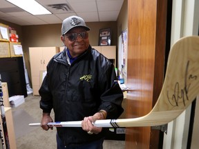 Fred Sasakamoose checks out some autographed sticks at the Oilers offices in Edmonton, Alberta on Saturday, March 29, 2014.  Perry Mah/ Edmonton Sun/ QMI Agency