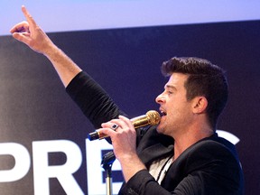 Robin Thicke appeared Wednesday at a store opening in Times Square, but won't be at MTS Centre on Sunday night after organizers said he was placed on "mandatory vocal rest." (WENN.COM PHOTO)
