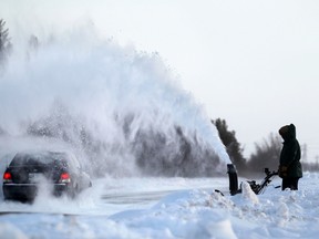 A car passes through a shower of snow from a snowblower on McCreary Road near Fort Whyte Alive last month. Another storm is forecast to hit Winnipeg. (Kevin King/Winnipeg Sun file photo)