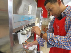 Justin Jacob makes an ice cream cone at BDI, which opened this weekend. The ice cream store was voted the best place to take a date by Sun readers. (CHRIS PROCAYLO/WINNIPEG SUN)