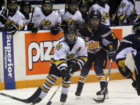 Kayden Laporte-Hayes (in white) of the Sarnia Lady Sting atom 'C' team carries the puck through a group of Ildteron Jets defenders during game three of their Western Ontario Girls Hockey League championship series on Saturday, March 29. Sarnia and Ilderton tied that game 1-1 before Ildteron won 1-0 on Sunday to force a game five in Sarnia on Saturday, April 5. SHAUN BISSON/THE OBSERVER/QMI AGENCY