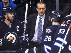 Winnipeg Jets head coach Paul Maurice speaks to his team during a break in play against the Dallas Stars during NHL action at MTS Centre in Winnipeg, Man., on Sun., March 16, 2014. Kevin King/Winnipeg Sun/QMI Agency