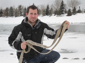 Stuart Harris holds the tow strap he used to help rescue a stranger from the icy water in Elliston Park in southeast Calgary, Alta on Sunday March 30, 2014.
Harris was driving past the park when he spotted a woman in the water. Using the rope, Harris and two Calgary police officers managed to get the woman out of the water safely. Jenna McMurray/Calgary Sun/QMI Agency