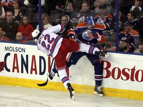 Edmonton Oilers' Anton Belov is checked into the boards by New York Rangers' Brian Boyle during first period NHL action at Rexall Place in Edmonton, Alberta on Sunday, March 30, 2014.  Perry Mah/Edmonton Sun