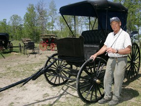 Al Oeming stands next to his historical Extension-Top Surrey wagon, which carried Sir Wilfred Laurier when he was prime minister of Canada early last century. (File photo)