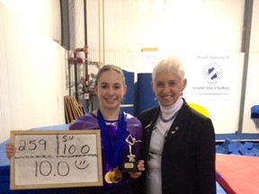 Sudbury Laurels gymnast Brooklyn Lavallee (left) poses with her perfect 10 score from brevet judge Ruth Uren at the GymZone on Sunday.