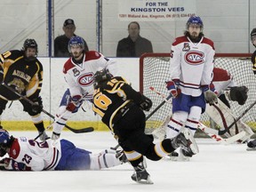 Kingston Voyageurs' Jarret Kup braces for impact on a shot from Aurora Tigers Dylan Sikura during Game 2 of their best-of-seven North-East Conference final at the Invista Centre on Sunday. (Julia McKay/Kingston Whig-Standard/QMI Agency)