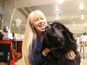 Gino Donato/The Sudbury Star (File Photo)
Christina Koffman-Heard snuggles with Michael the Newfoundland, who won best in show on Saturday at the Nickel District Kennel Club Championship Dog Show at the Coniston Arena.
