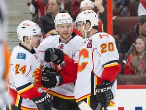 Calgary Flames centre Matt Stajan (middle) is congratulated by teammates after scoring in the first period of a 6-3 loss to the Senators on Sunday night. Stajan and the Flames are in Toronto to face the struggling Maple Leass on Tuesday night. (Marc Desrosiers/USA Today Sports)