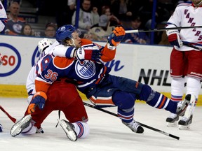 Oilers' Philip Larsen is hauled down by New York's Marc Staal Sunday night at Rexall Place (Perry Mah, Edmonton Sun).
