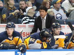 Buffalo Sabres head coach Ted Nolan watches play from behind the bench during the first period against the Calgary Flames at First Niagara Center on Dec 14, 2013 in Buffalo, NY, USA. (Kevin Hoffman/USA TODAY Sports)